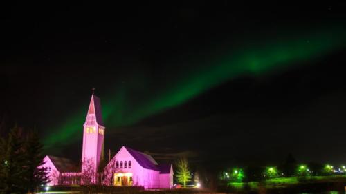Selfoss Church with dancing northern lights